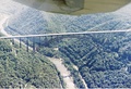 The New River Gorge Bridge as seen from a small fixed-wing airplane. The Tunney Hunsaker Bridge is also visible.