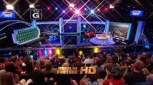 A screen shot of Wheel of Fortune, showing the entirety of the show's set