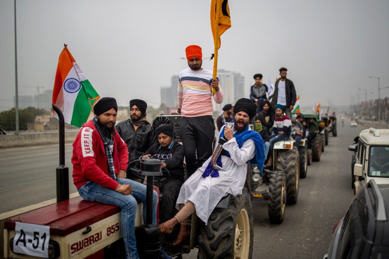 Farmers take out a tractor rally in a protest against new farm laws at Ghaziabad, outskirts of New Delhi, India, Thursday, Jan. 7, 2021. Indian farmers who have blockaded key highways for weeks say they'll continue their protests for new agricultural laws to be repealed. (AP Photo/Altaf Qadri)