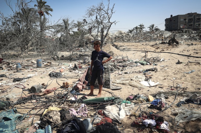 A Palestinian youth stands at the site of Israeli strikes on a makeshift displacement camp in Mawasi in Khan Yunis in the southern Gaza Strip on September 10, 2024 [Eyad BABA / AFP]