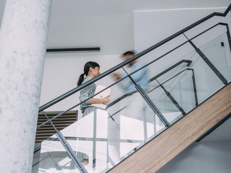 Professionals walking up and down a busy stairwell