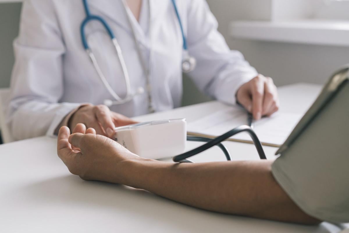 Patient having blood pressure and pulse examed during annual checkup