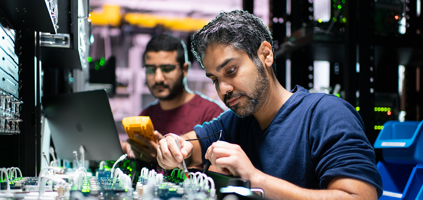 ATwo Apple engineers work on iPhone components in a lab