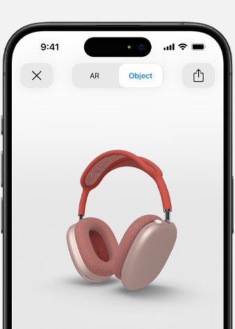 Kuva pinkeistä AirPods Max ‑kuulokkeista lisätyn todellisuuden näkymässä iPhonessa.