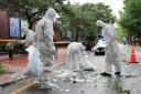 Officers wearing protective gear collect the trash from a balloon in Seou on Wednesday (Park Dong-joo/Yonhap/AP)