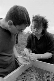 Scott Miller (CAS'02) and Beaudry look for artifacts on a sifting screen on Rainsford Island in Boston Harbor. Photo by Vernon Doucette