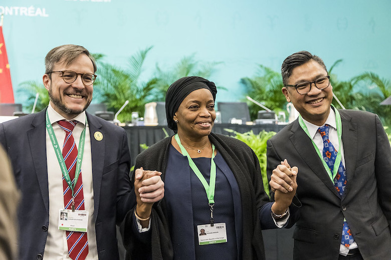 Three party delegates celebrate the agreement of the Kunming-Montreal Global Biodiversity Framework (GBF), 19 December 2022. Credit: UN CBD.