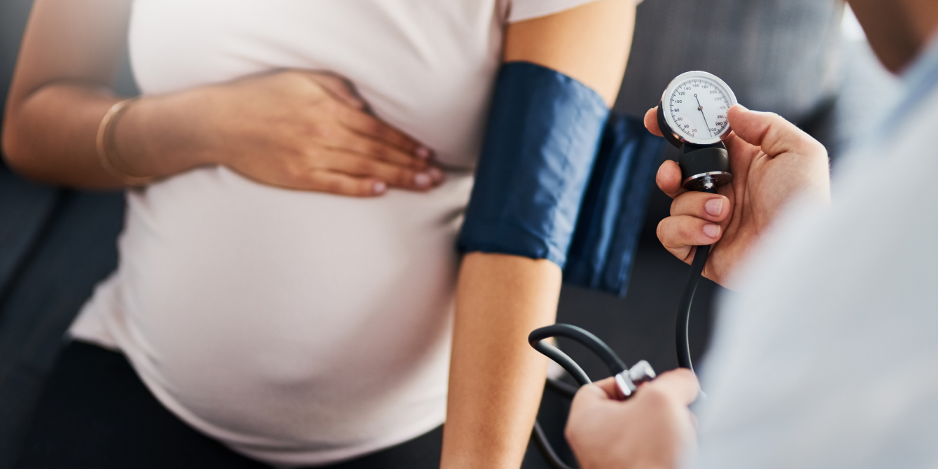 Closeup shot of a doctor checking a pregnant woman's blood pressure