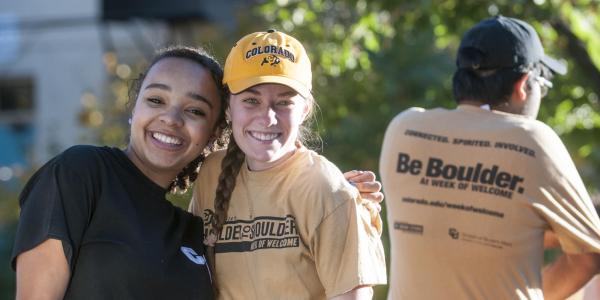 Two friends embrace for a photo at the 2014 Homecoming parade