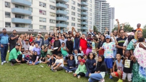 Tenants and their family members pose for a photo outside their building in this undated photo. More than 100 tenants living at 1440 and 1442 Lawrence Ave. West, went on rent strike last October seeking urgent repairs in dozens of units and upset about the proposal of rent increases above provincial guidelines. THE CANADIAN PRESS/HO York South-Weston Tenant Union.