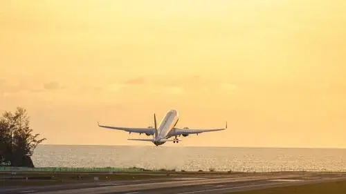 Plane taking off over body of water