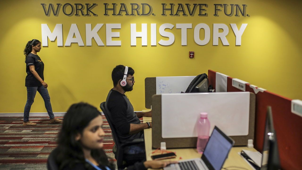 The Amazon motto "Work hard. Have fun. Make history" is displayed on an office wall at the Amazon campus in Hyderabad, India