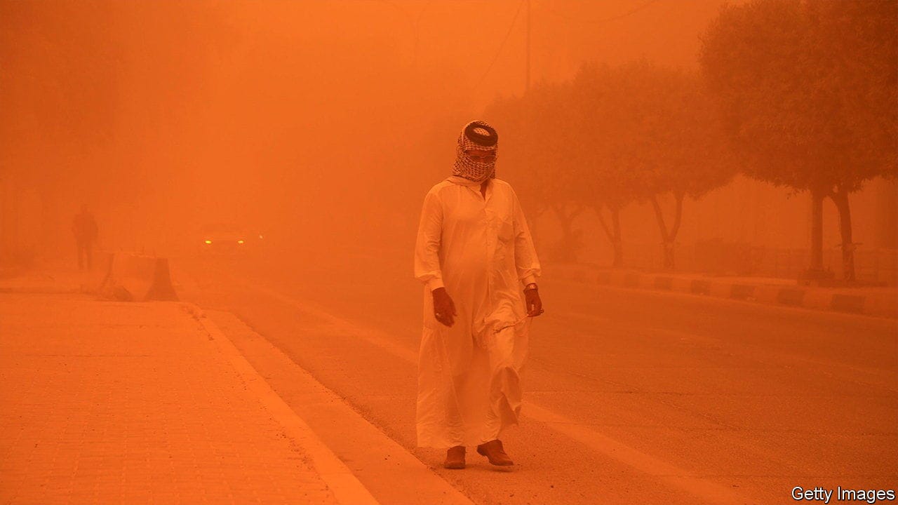BAGHDAD, IRAQ - MAY 16: A man protects his face as dust cover the city during sandstorm in Baghdad, Iraq on May 16, 2022. Visibility degraded in traffic due to the sandstorm. (Photo by Murtadha Al-Sudani/Anadolu Agency via Getty Images)