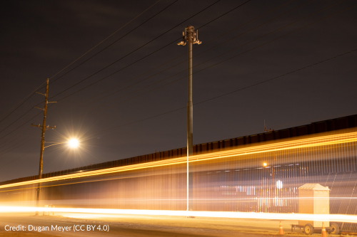 A surveillance tower at night along the border fence in Calexico, California.
