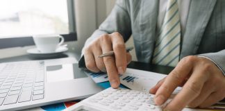 Businessman using calculator for finance accounting