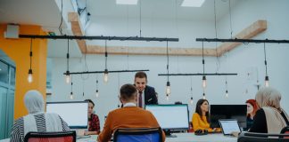 A group of employees working on a project in modern office