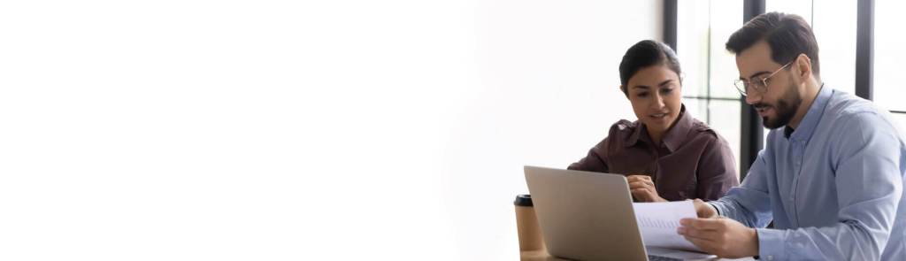 2 People at desk looking at paper