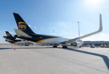 Ground view of brown-tailed UPS freighters on a sunny day, as seen from side rear.