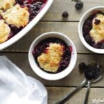 a close up of a Gluten-Free Blackberry Cobbler in a white baking dish