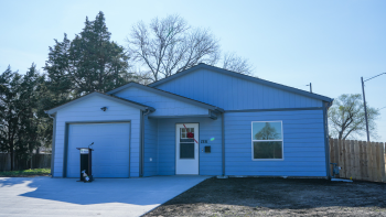 New Habitat home with a bow on the front door