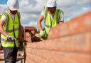 Undated Taylor Wimpey handout photo of workers laying bricks at a Taylor Wimpey construction site (PA)