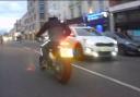 Image of the motorcyclist just before a girl, 9, and three men were shot in Kingsland Road, Dalston