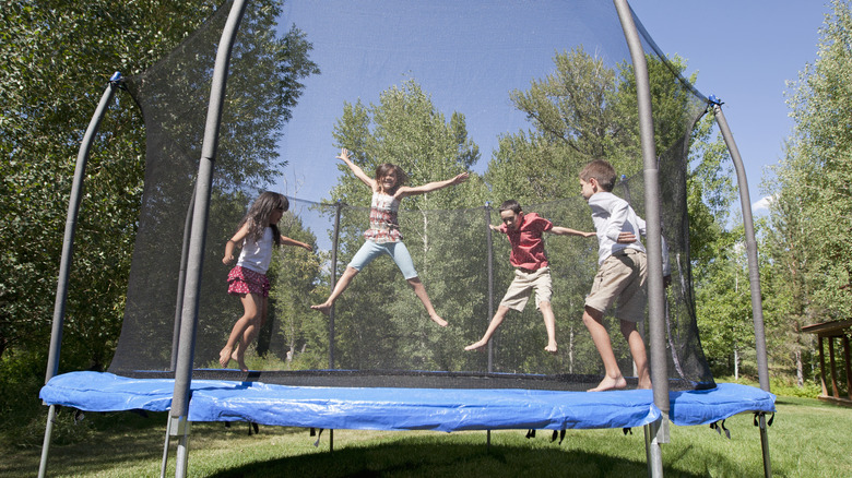 kids jumping on an outdoor trampoline