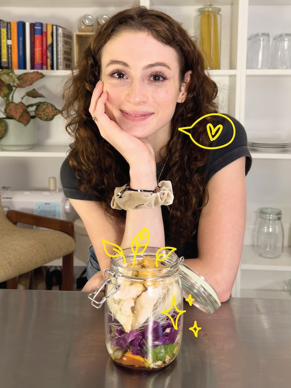 A woman posing in front of a glass jar filled with diced vegetables.