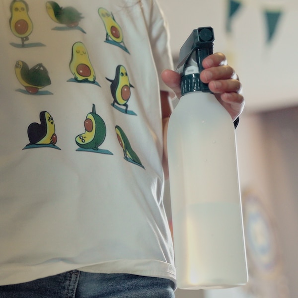 A young girl carries a PEPPRIG spray bottle.