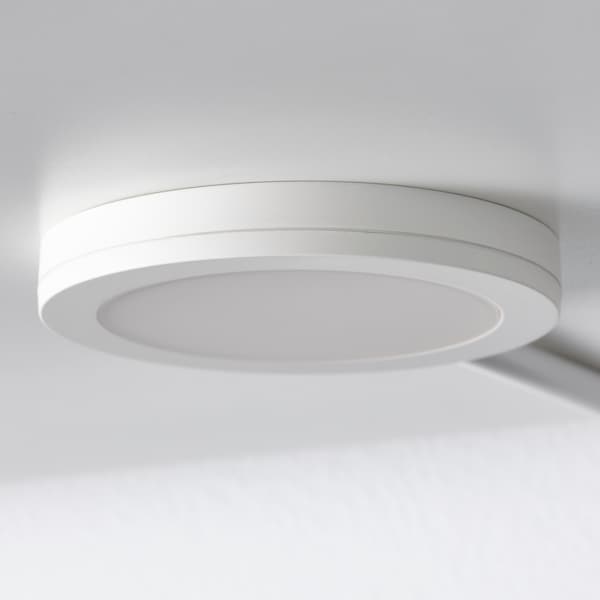 A white spotlight installed on the inside of a cabinet.