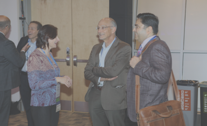 Photo of three people standing and talking