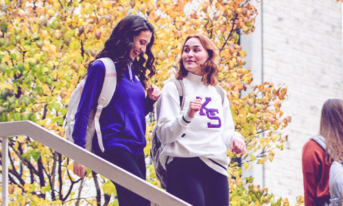 Two students walking through K-State's Manhattan, Kansas campus