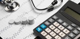 A calculator being used to calculate an emergency fund