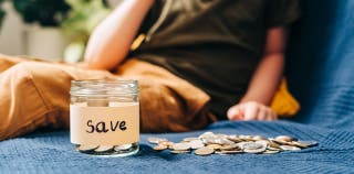 A saving jar that is full of coins