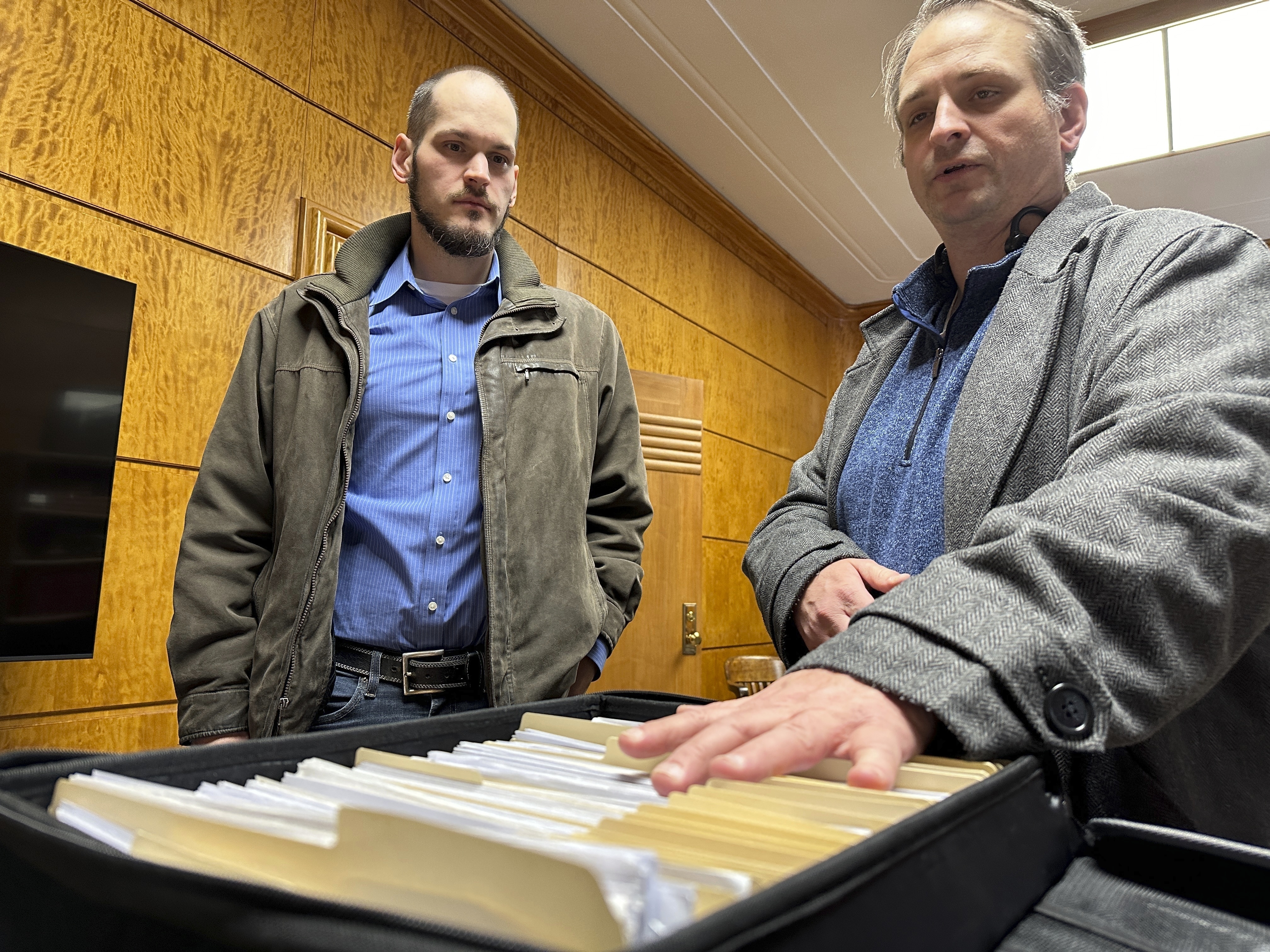 FILE - Retire Congress North Dakota Chairman Jared Hendrix, left, and U.S. Term Limits National Field Director Scott Tillman look over petitions they submitted for a North Dakota congressional age limit ballot initiative on Friday, Feb. 9, 2024, at the state Capitol in Bismarck, N.D. North Dakota voters on Tuesday, June 11, 2024, approved a ballot initiative that bars anyone who would be 81 years old during his or her U.S. House or Senate term from running for Congress. (AP Photo/Jack Dura, File)