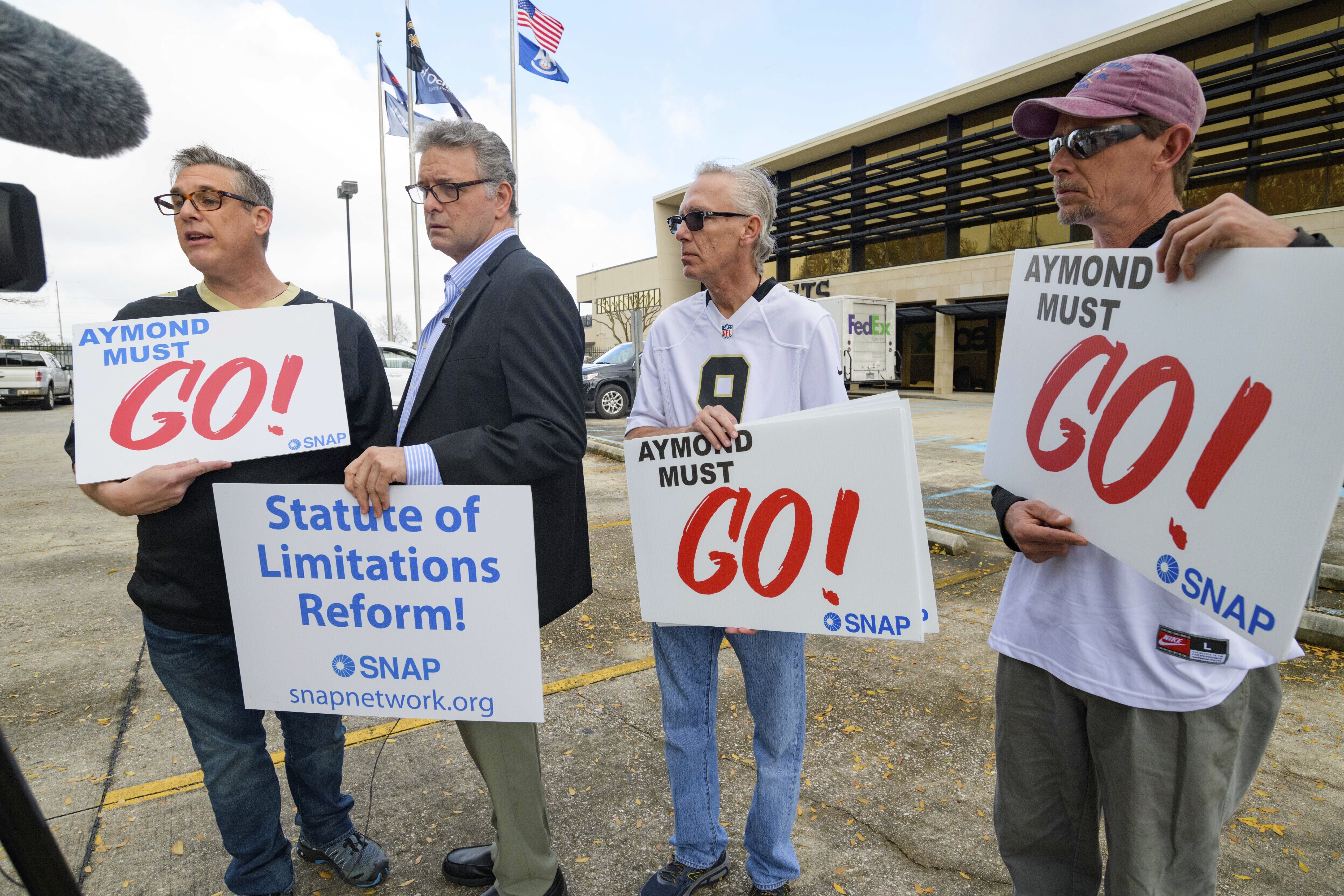 FILE - Members of SNAP, the Survivors Network of those Abused by Priests, including, from left, Kevin Bourgeois, John Gianoli, Richard Windmann and John Anderson, hold signs during a conference in front of the New Orleans Saints training facility, Jan. 29, 2020, in Metairie, La. Officially reversing a controversial March ruling, Louisiana’s highest court on Wednesday, June 12, 2024, gave childhood victims of sexual abuse a renewed opportunity to file damage lawsuits. (AP Photo/Matthew Hinton, File)