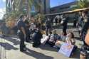 In this photo provided by Ashley Young, Honolulu police officers talk to demonstrators sitting outs…