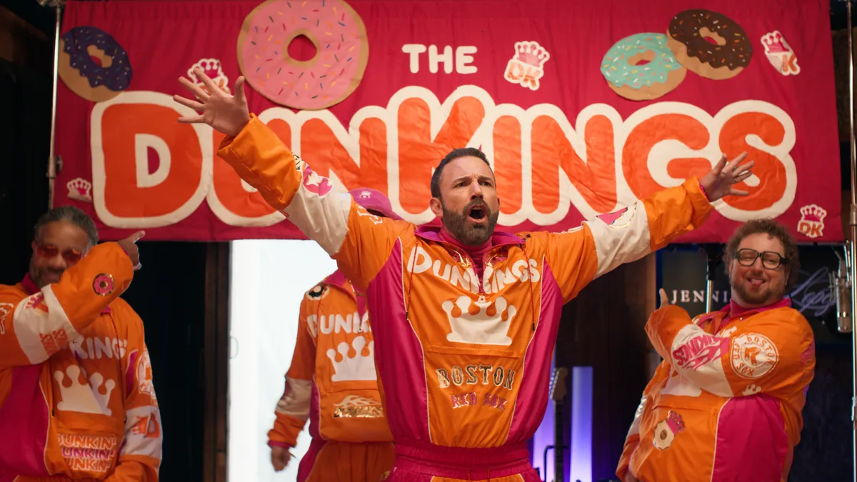 Ben Affleck wears a branded Dunkin' sweatsuit and introduces The DunKings as part of the chain's Super Bowl LVIII ad.
