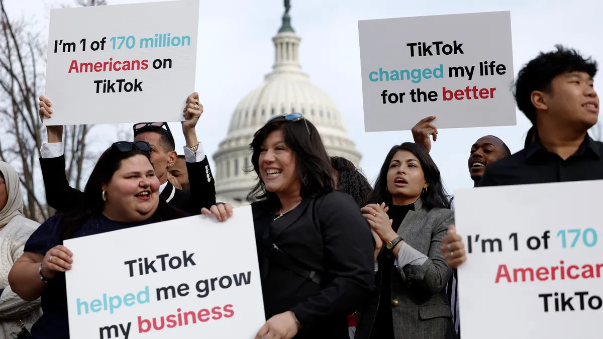 Individuals hold signs in support of TikTok outside the U.S. Capitol Building on March 13, 2024 in Washington, DC.