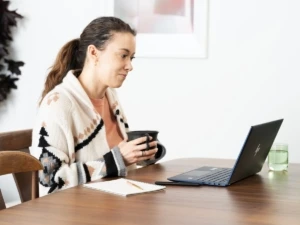 Adult male working from home viewing a Skype call on Surface laptop 3