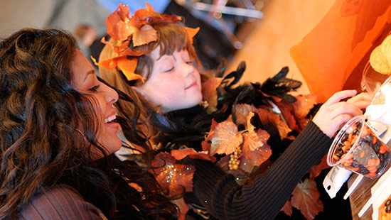 Picture of student and child dressed in costume at Project Pumpkin