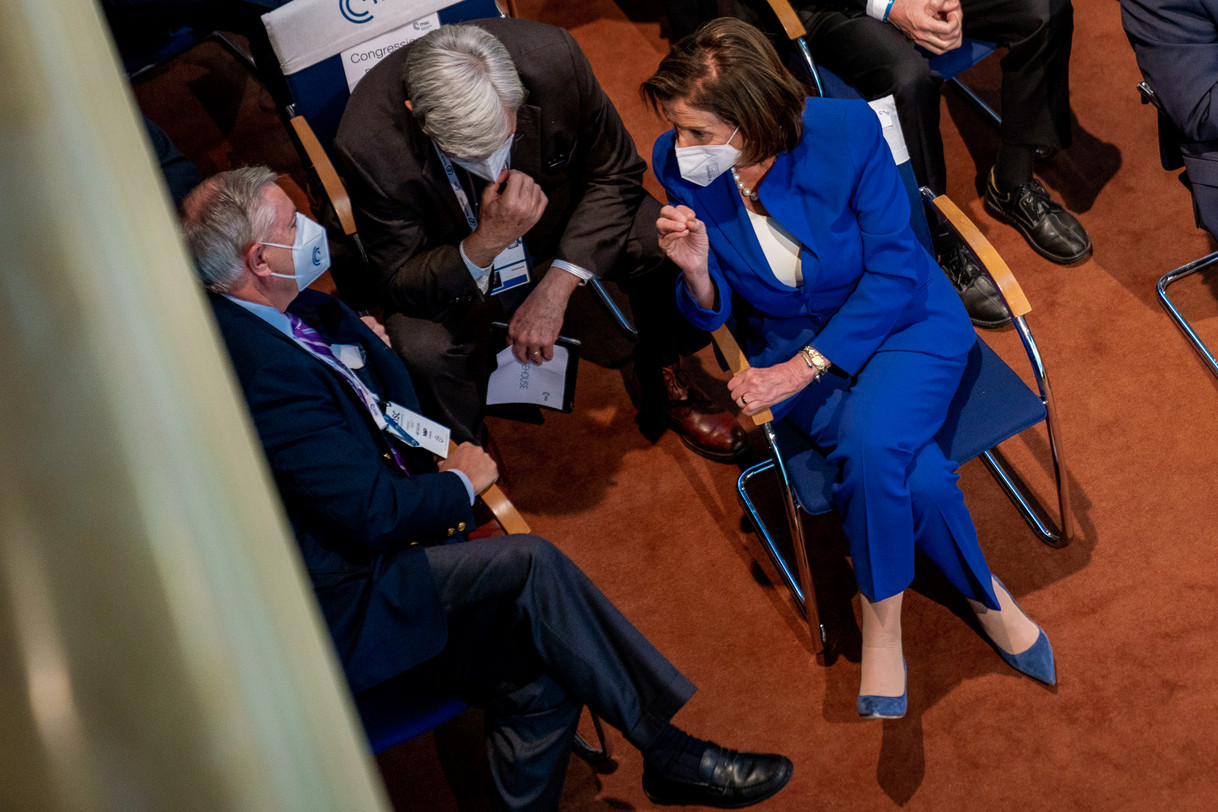 Sens. Lindsey Graham and Sheldon Whitehouse conversing with then-House Speaker Nancy Pelosi white seated in a circle.