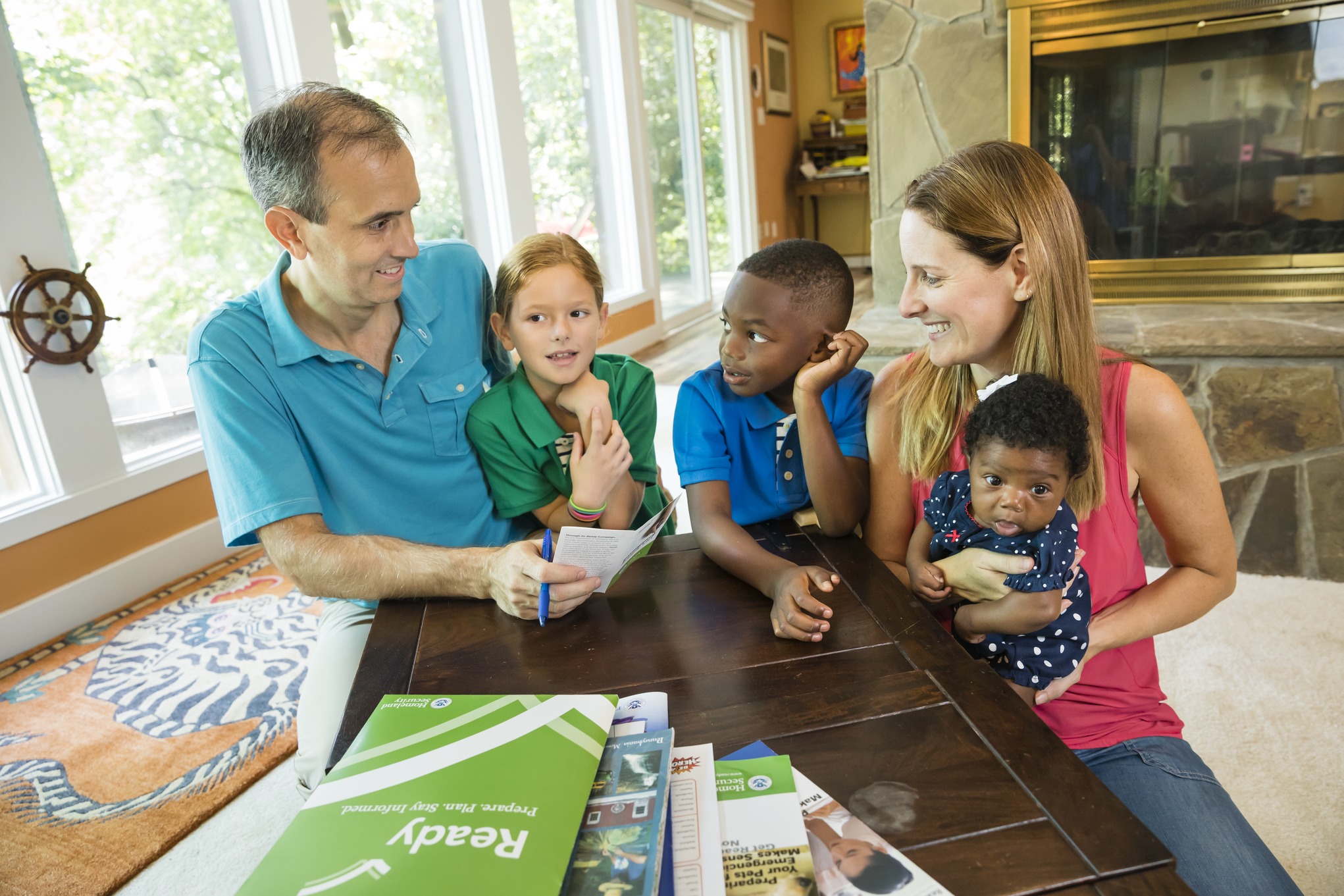 Family of 5 preparing for emergency checking emergency preparedness list