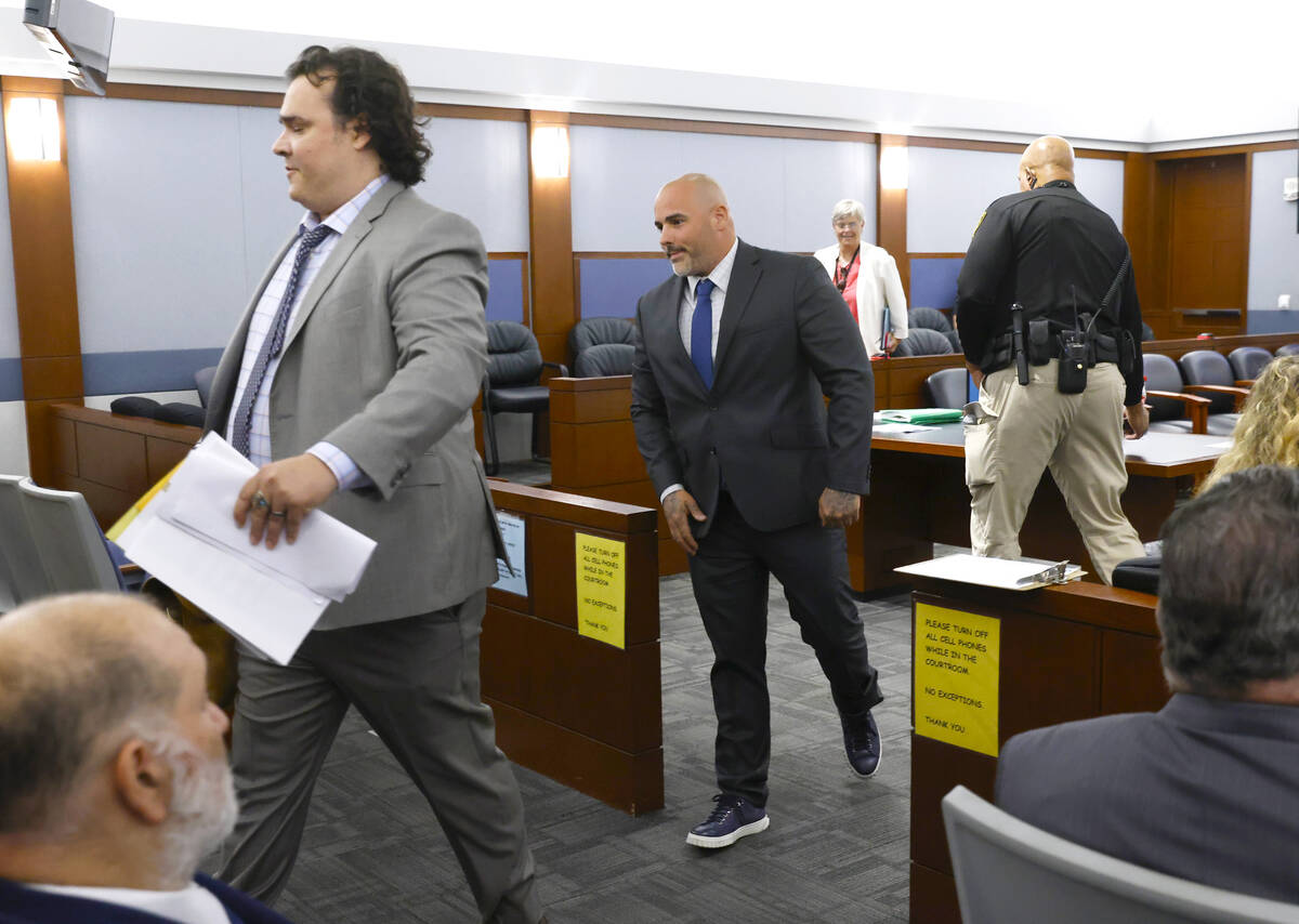 Steven Gazlay, center, who was accused of theft, conspiracy to commit theft and mortgage lendin ...