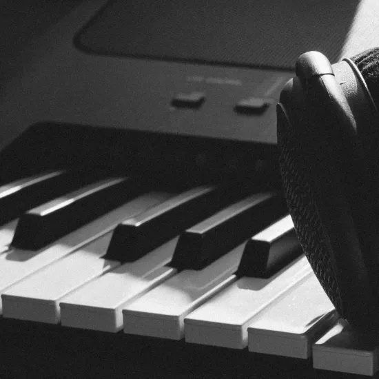 Electronic piano with headphones resting on keys