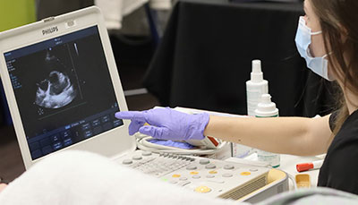 Student working with an ultrasound machine. 