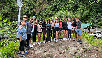 Group of students and faculty in an outdoor setting, studying abroad.