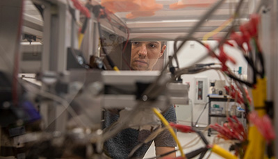 Student looking inside an engineering device.