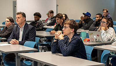 Students in desks in a classroom.