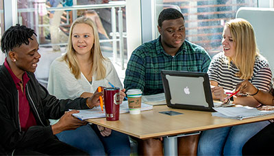 Group of business students working together at a table. 